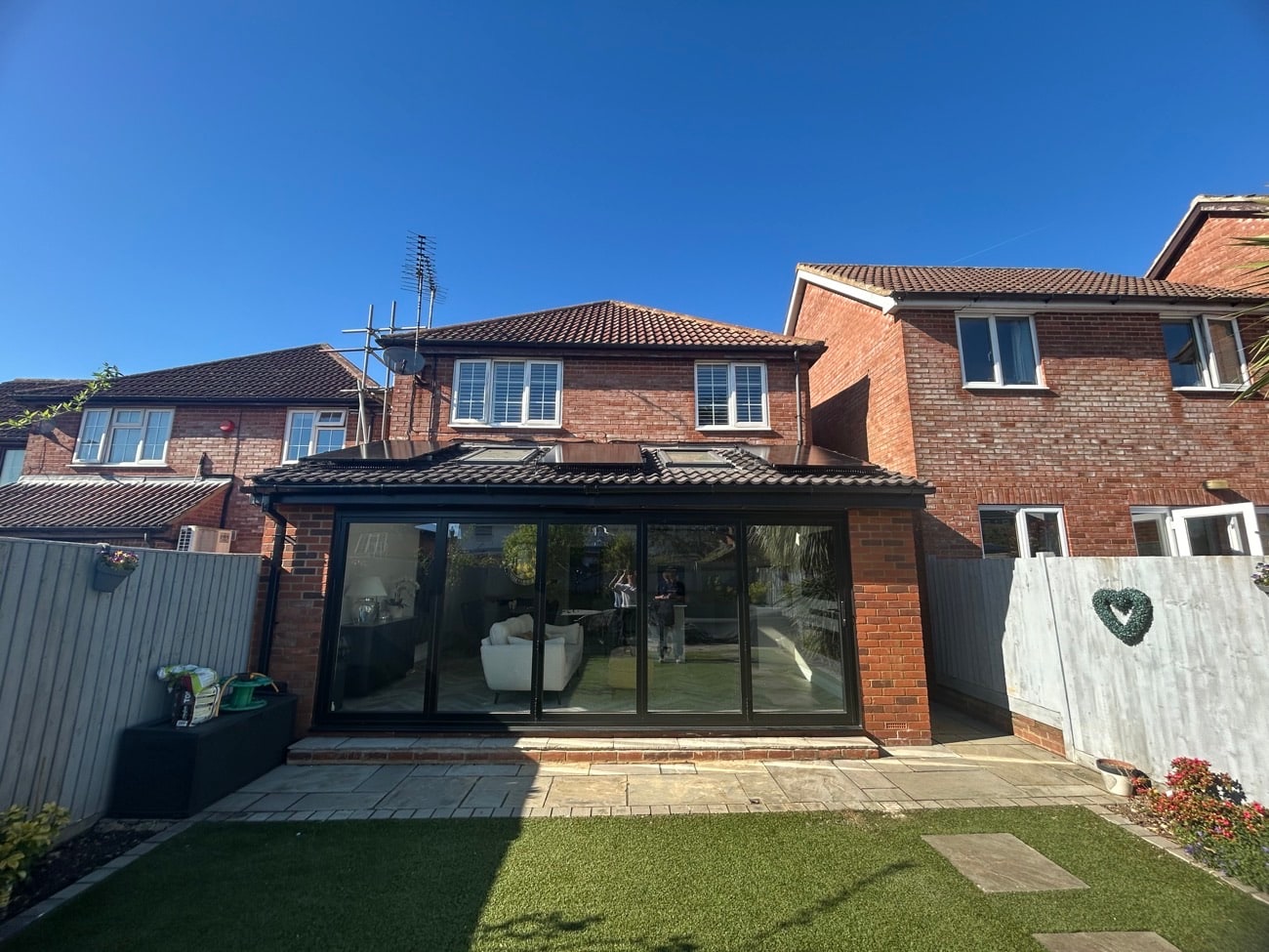 Completed home with solar panels on the rear extension roof