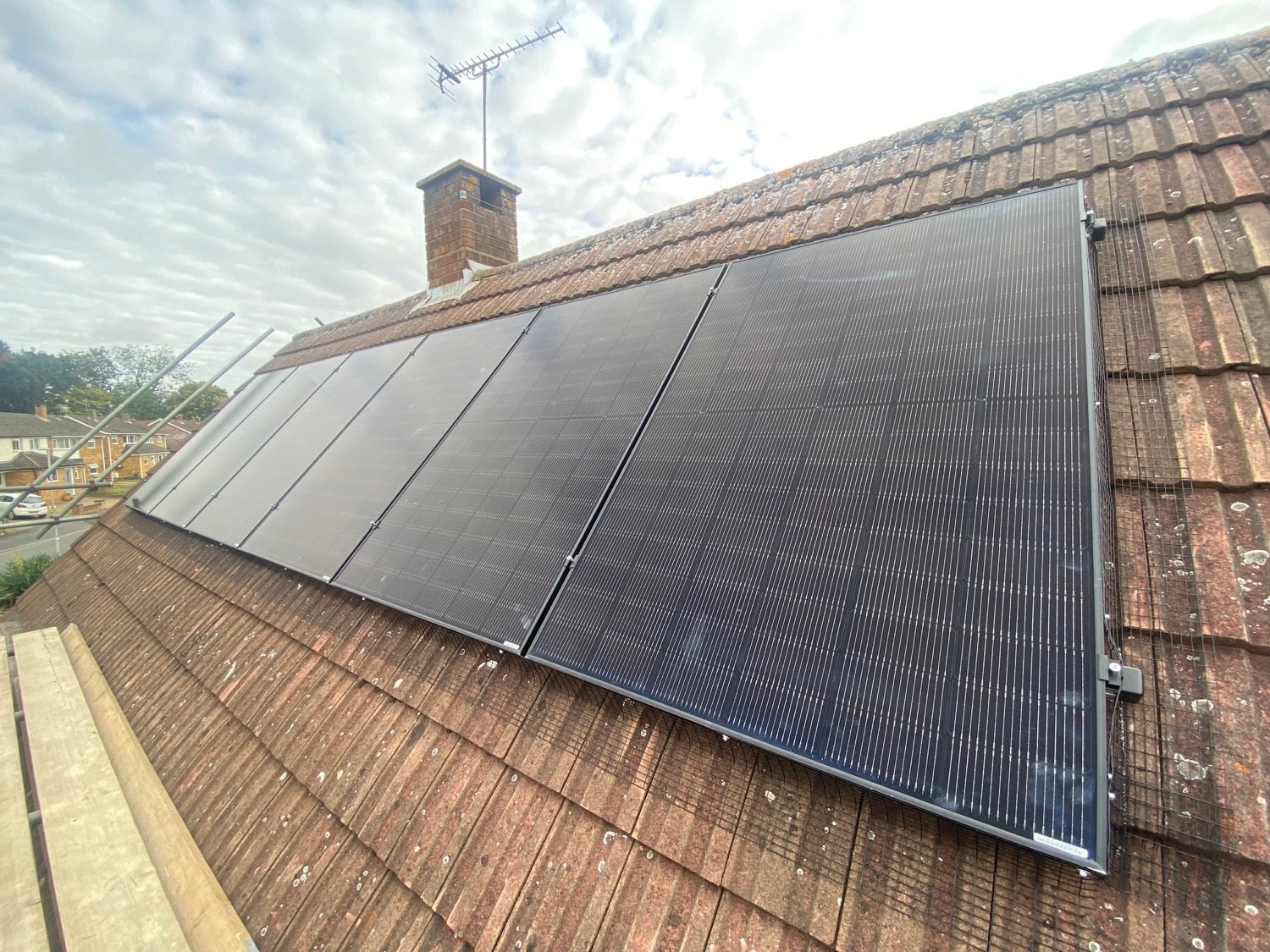 Black anti-bird mesh fitted around the edge of a solar panel array to stop birds nesting underneath