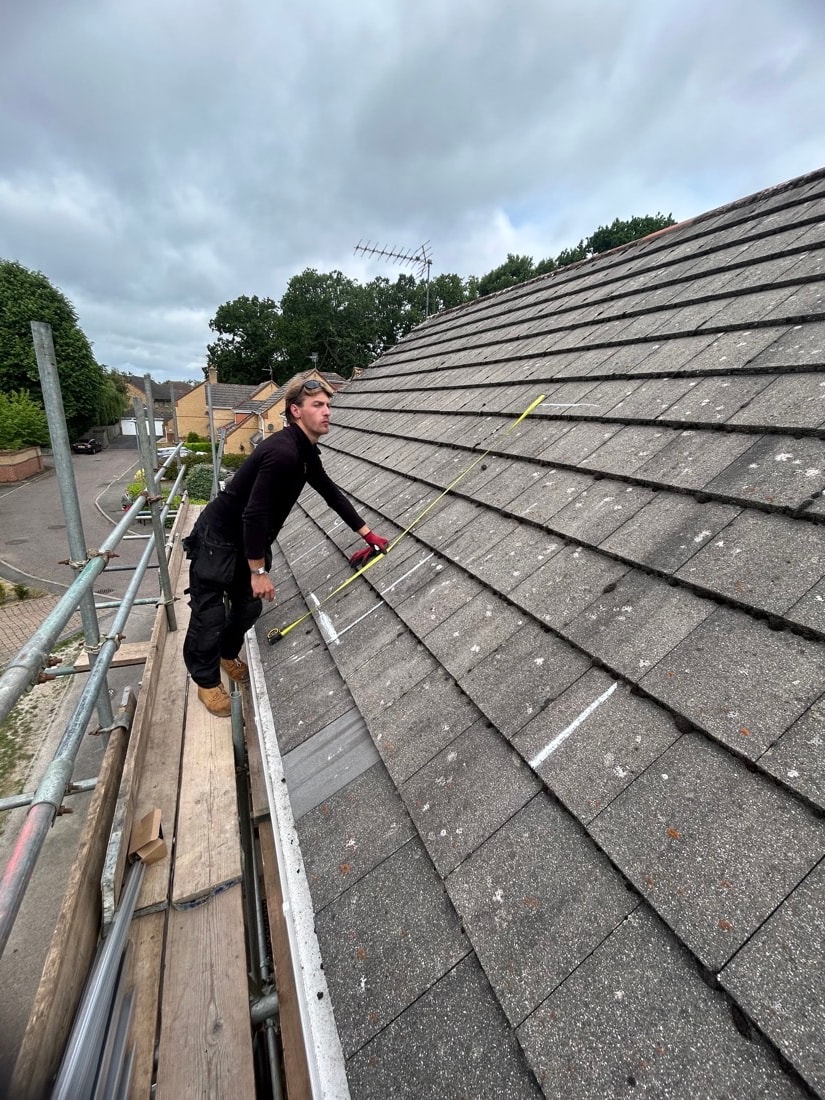 Solar installer measuring a roof during a maintenance visit